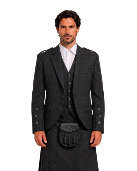 Man wearing black wool argyle jacket with black kilt underneath against white background.
