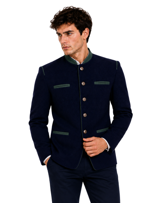 Man wearing a navy blazer with green accents on a white background