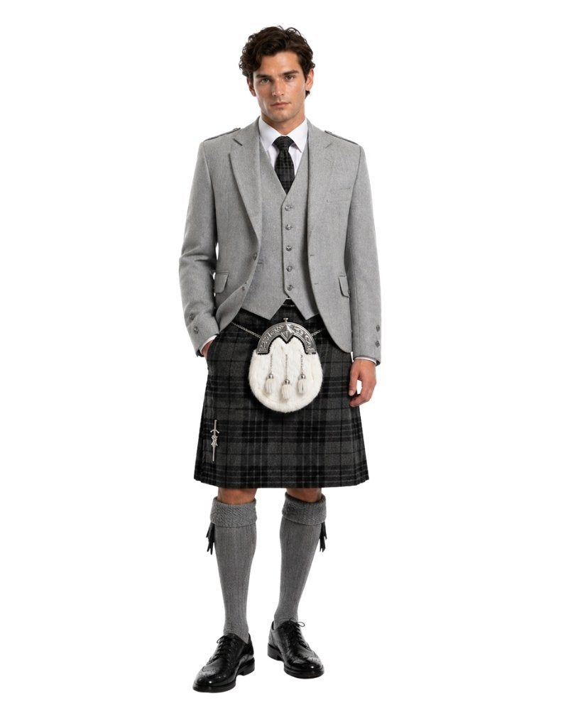Man wearing a traditional Scottish kilt with a gray jacket and socks on a white background