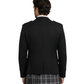 Person wearing a black blazer and plaid kilt on a white background