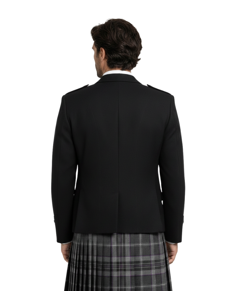 Person wearing a black blazer and plaid kilt on a white background