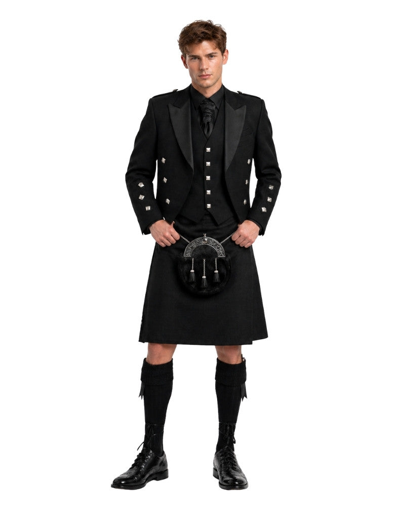 Man wearing a traditional black Scottish kilt with jacket and boots on a white background