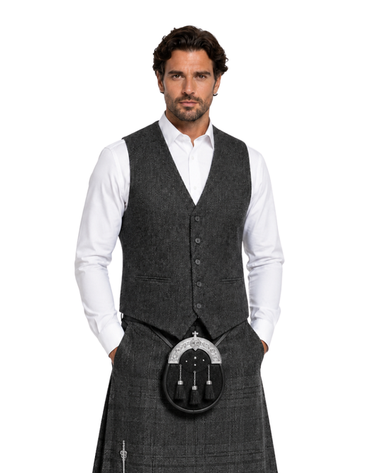 Man wearing a gray tweed kilt with a waistcoat on a white background