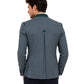 Man wearing a dark green blazer with green trim on a white background