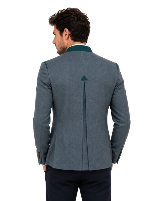 Man wearing a dark green blazer with green trim on a white background