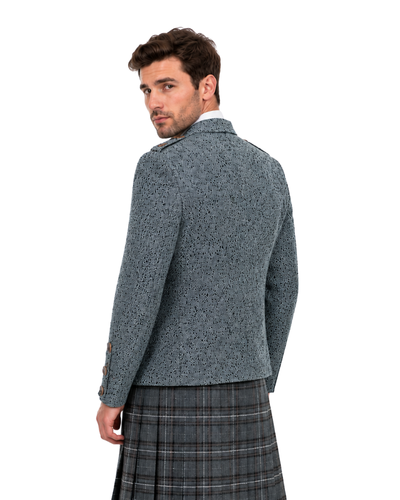 Man wearing a patterned jacket and plaid kilt on a white background