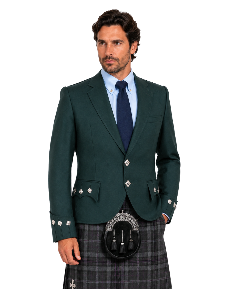 A man modeling a dark green Scottish kilt suit jacket with silver decorative buttons, paired with a gray plaid kilt, black sporran, and a light blue dress shirt with a navy tie, against a plain white background.