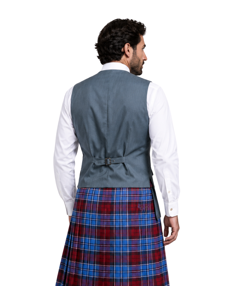 Man wearing a gray vest and red plaid kilt on a white background