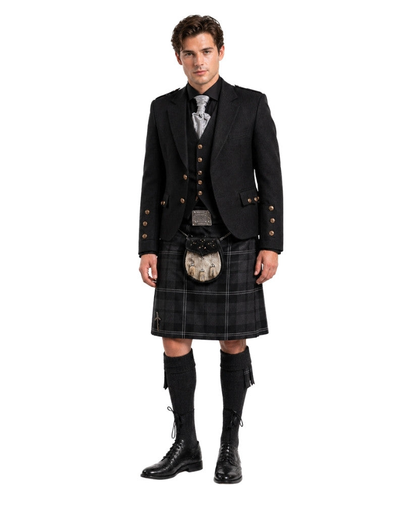 Man wearing a traditional Scottish kilt with jacket and boots on a white background