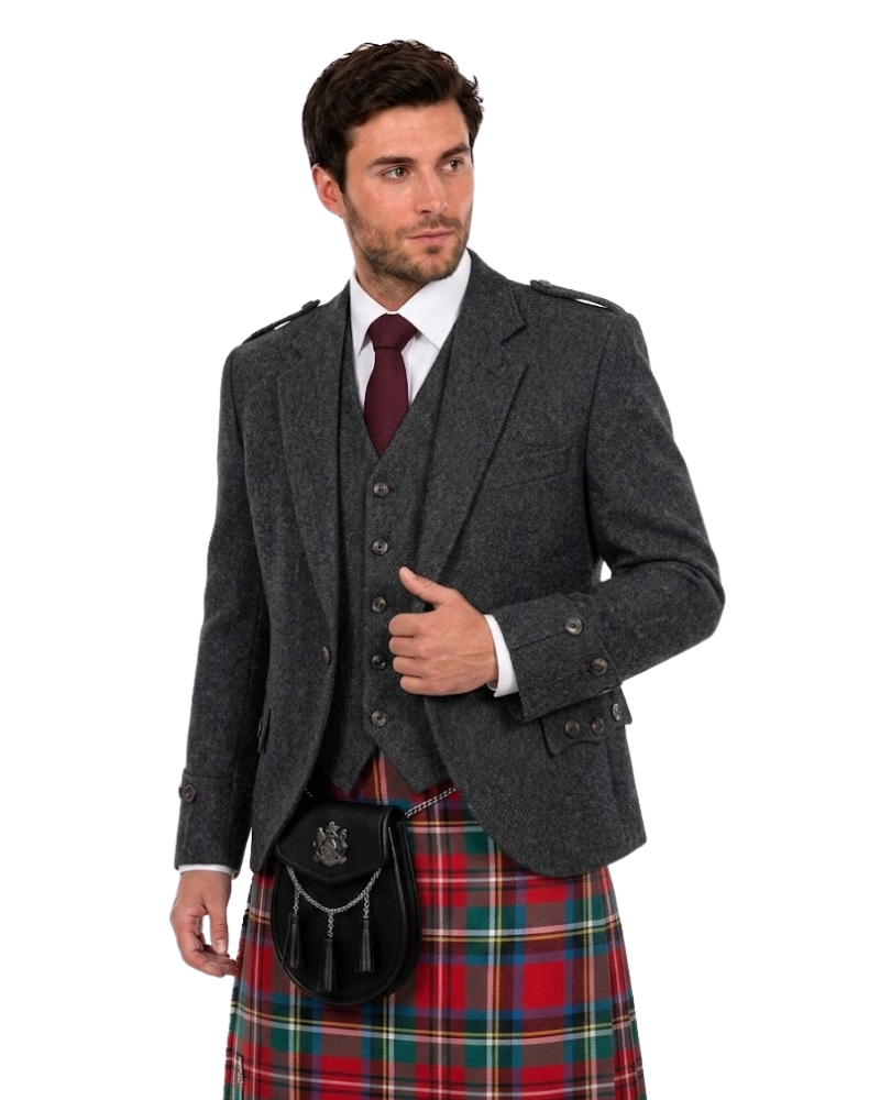 A man wearing a dark gray tweed blazer over a matching waistcoat, a white dress shirt, a burgundy tie, and a red, green, and blue tartan kilt with a black sporran bag, photographed against a plain white background.