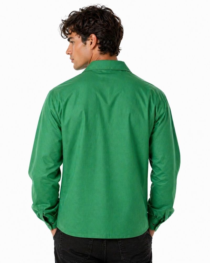 Man wearing a green long-sleeve shirt on a white background