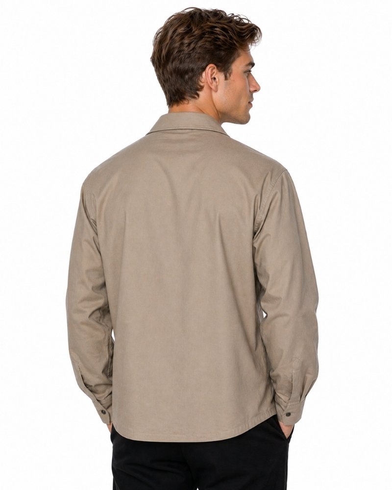 Man wearing a beige shirt on a white background