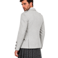 A man wearing a light gray blazer and a dark gray plaid kilt, shown from a three-quarters back view against a plain white background.