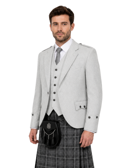 Man wearing a grey jacket with plaid kilt on a white background