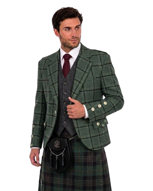 Man wearing a green blazer with plaid kilt against a white background