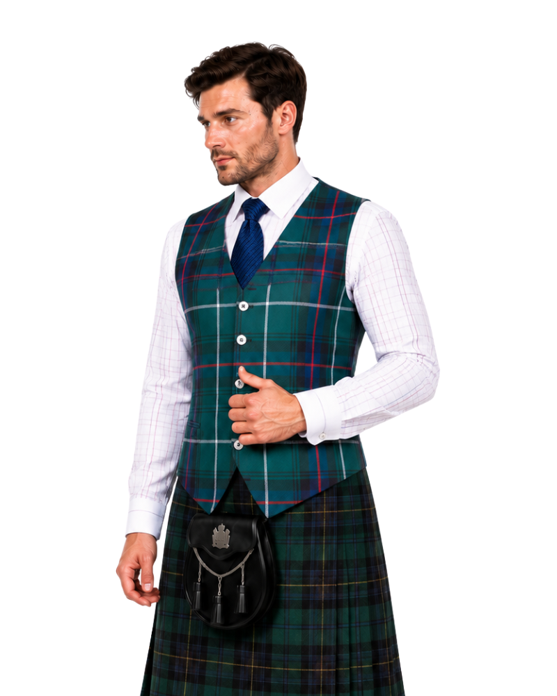 A man wearing a traditional Scottish kilt outfit, featuring a green tartan plaid waistcoat vest, matching kilt, a black sporran pouch, a white dress shirt, and a navy blue tie, set against a plain white background.