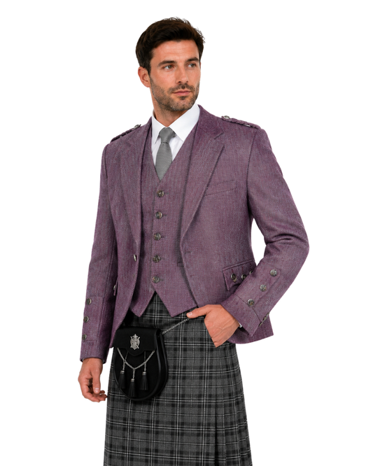 Man wearing a traditional Scottish outfit with a purple jacket, vest, and kilt on a white background.