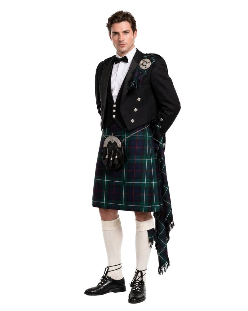 Man wearing a traditional Scottish kilt with a white background