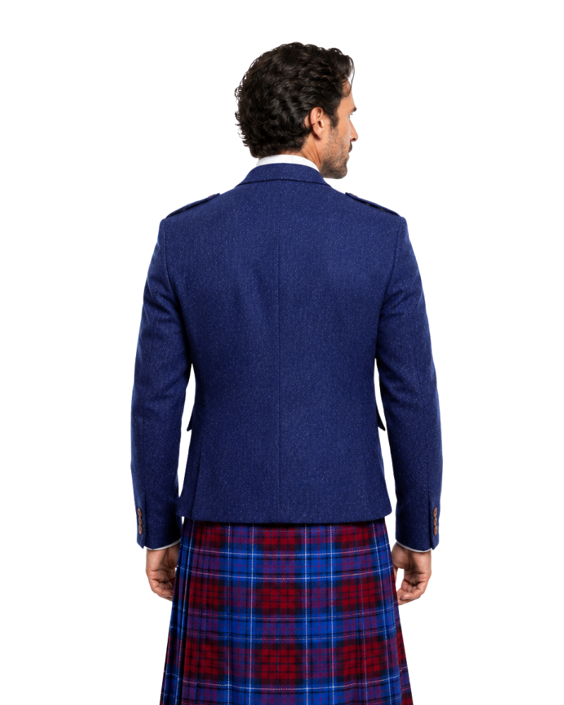 Man wearing a blue jacket and red plaid kilt on a white background
