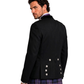 Man wearing a black jacket with tartan kilt on a white background