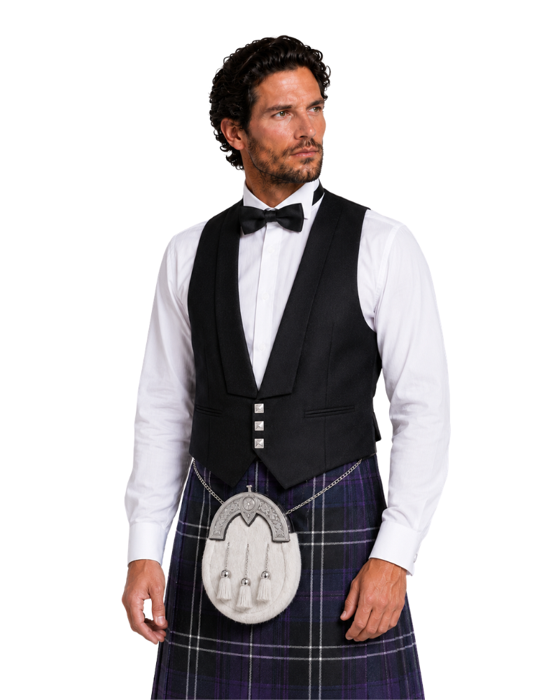 Man wearing a black vest, white shirt, and plaid kilt on a white background