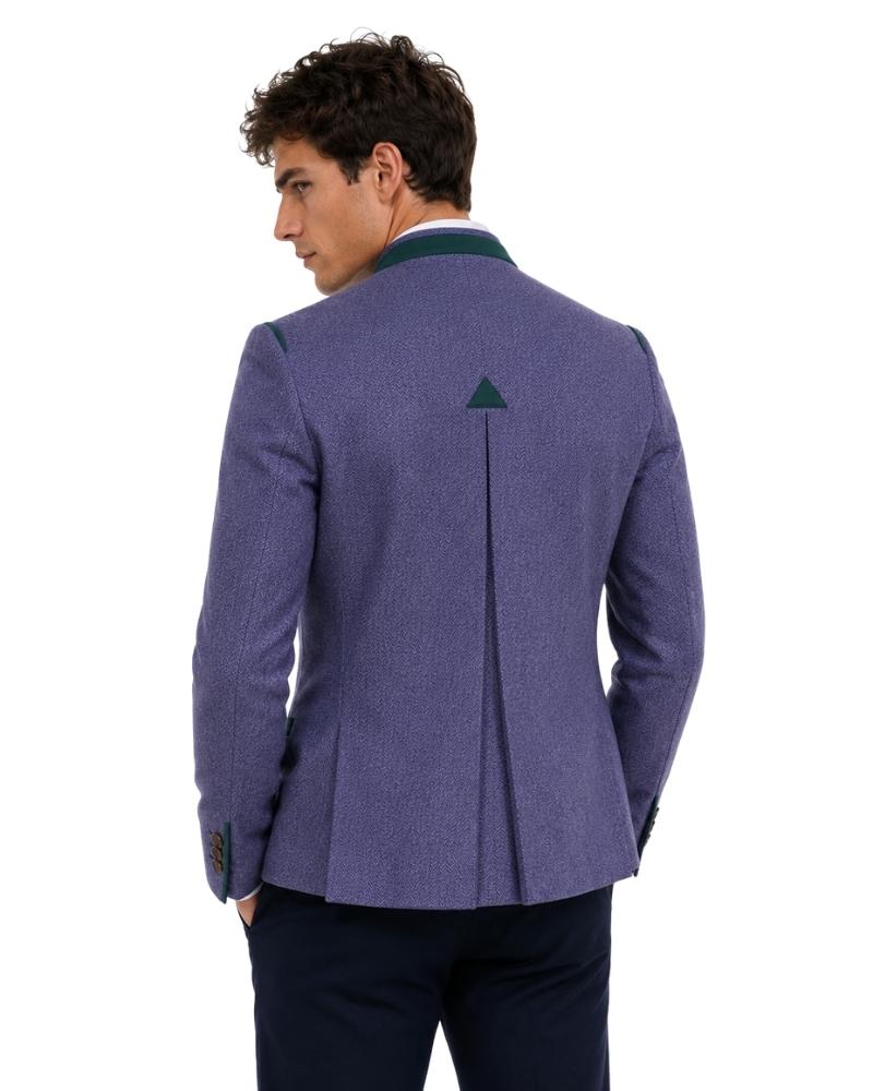 Man wearing a purple blazer with a green lapel on a white background