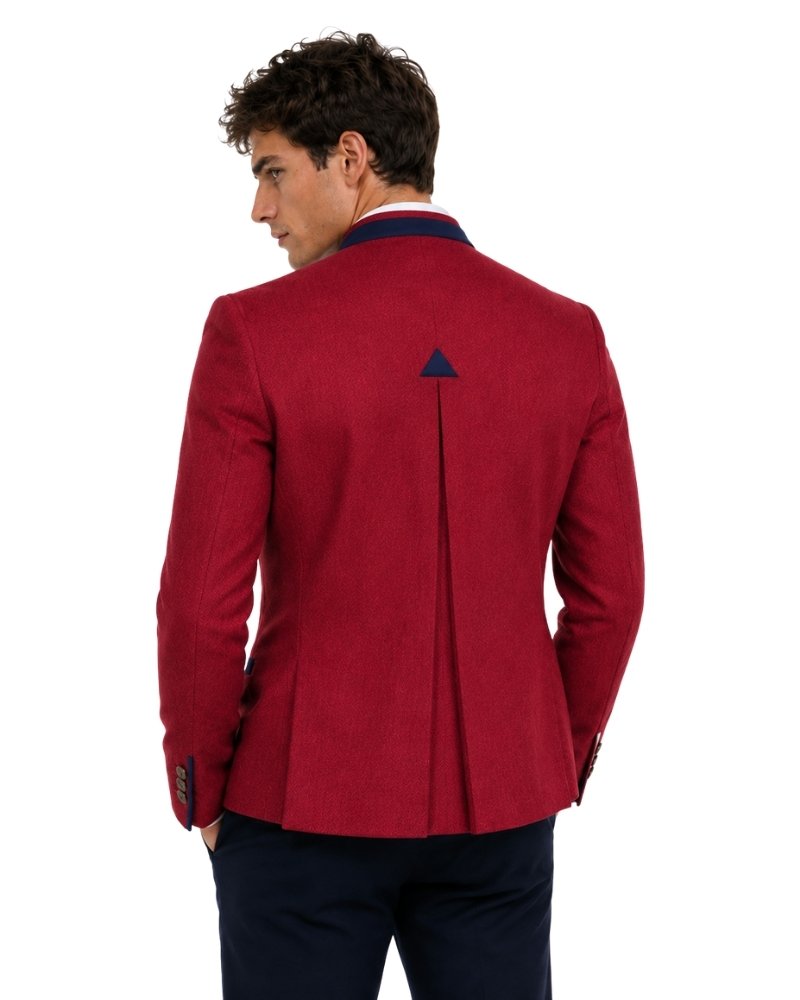 A man wearing red blazer with dark blue accents n white background