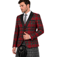 man wearing a red Royal Stewart tartan blazer with black satin shawl lapels, paired with a grey tartan kilt and a black leather sporran paired with a grey tartan kilt and a black leather sporran
