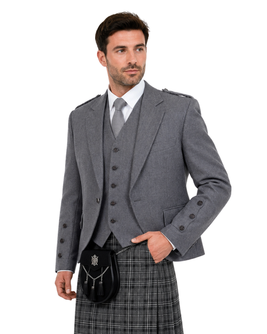Man wearing a gray Highland outfit with a kilt on a white background