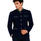 Man wearing a navy blazer with green accents on a white background