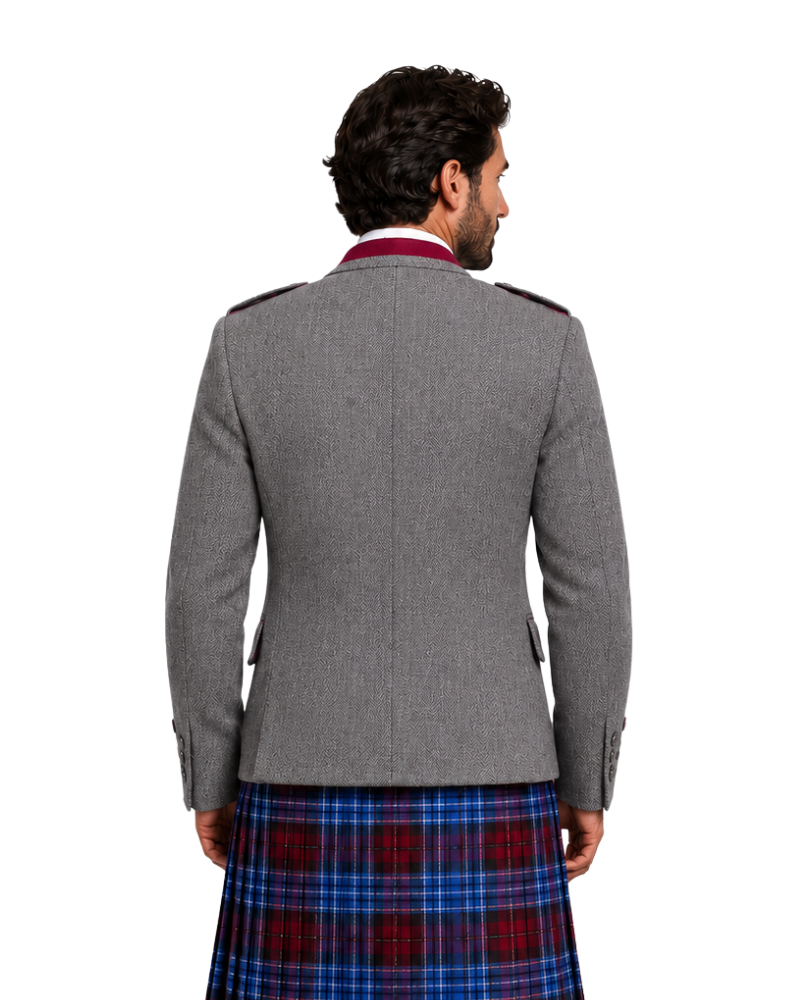 Person wearing a gray jacket and plaid kilt on a white background